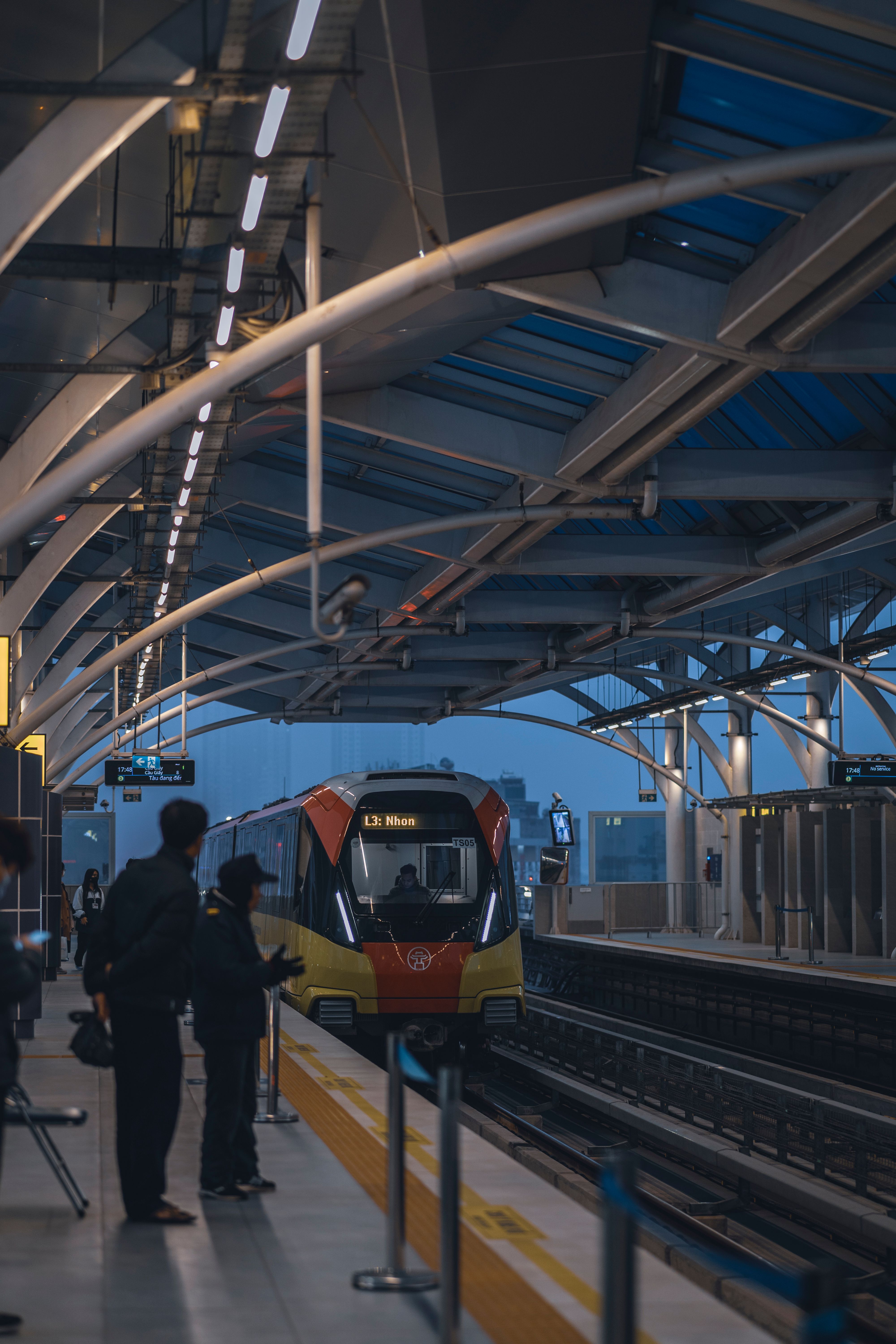 MRT train arriving at a station platform with passengers waiting in Singapore