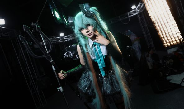 Anime character cosplay with unique costume indoors at event