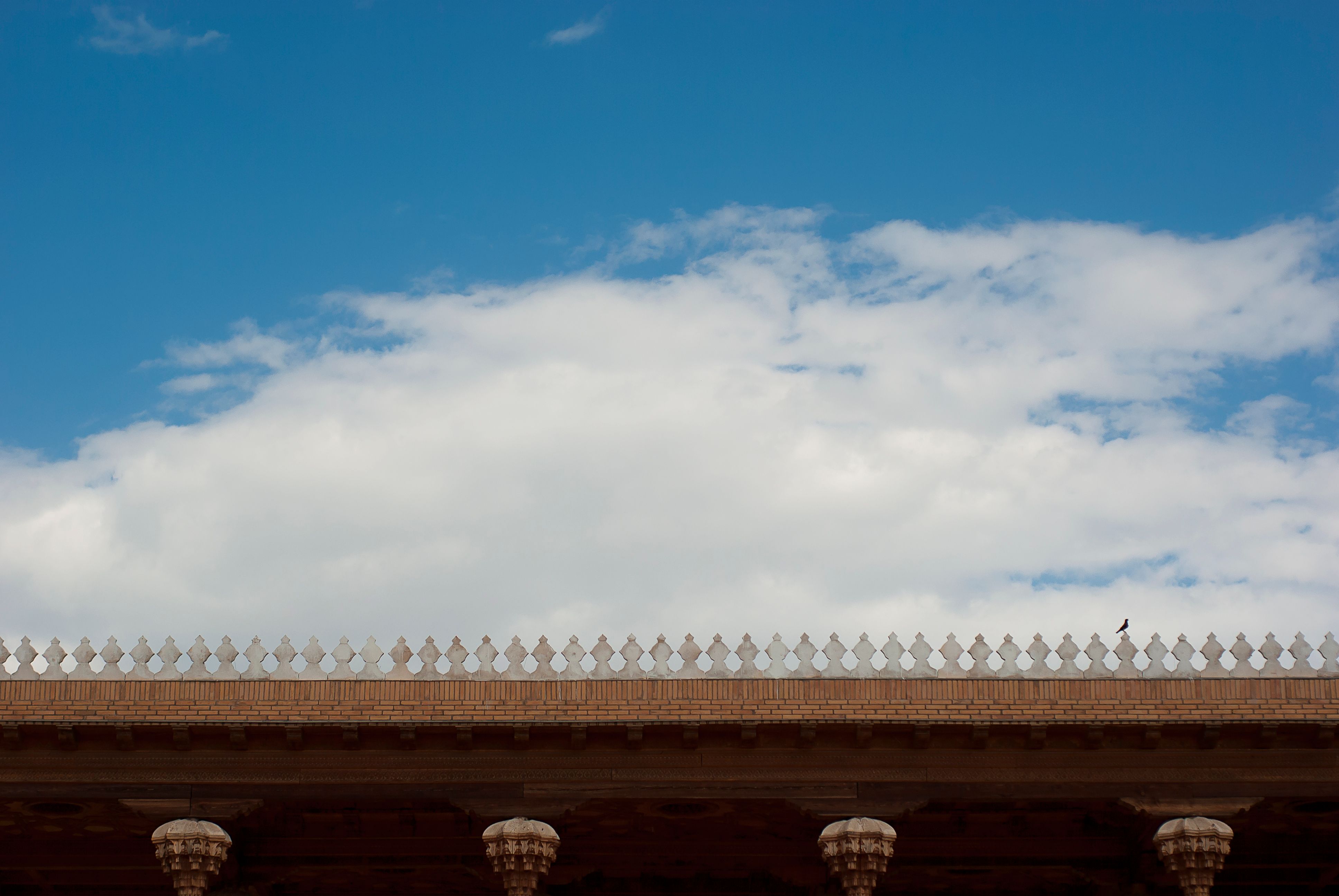 Elegant Architectural Roofline Against Blue Sky · Free Stock Photo