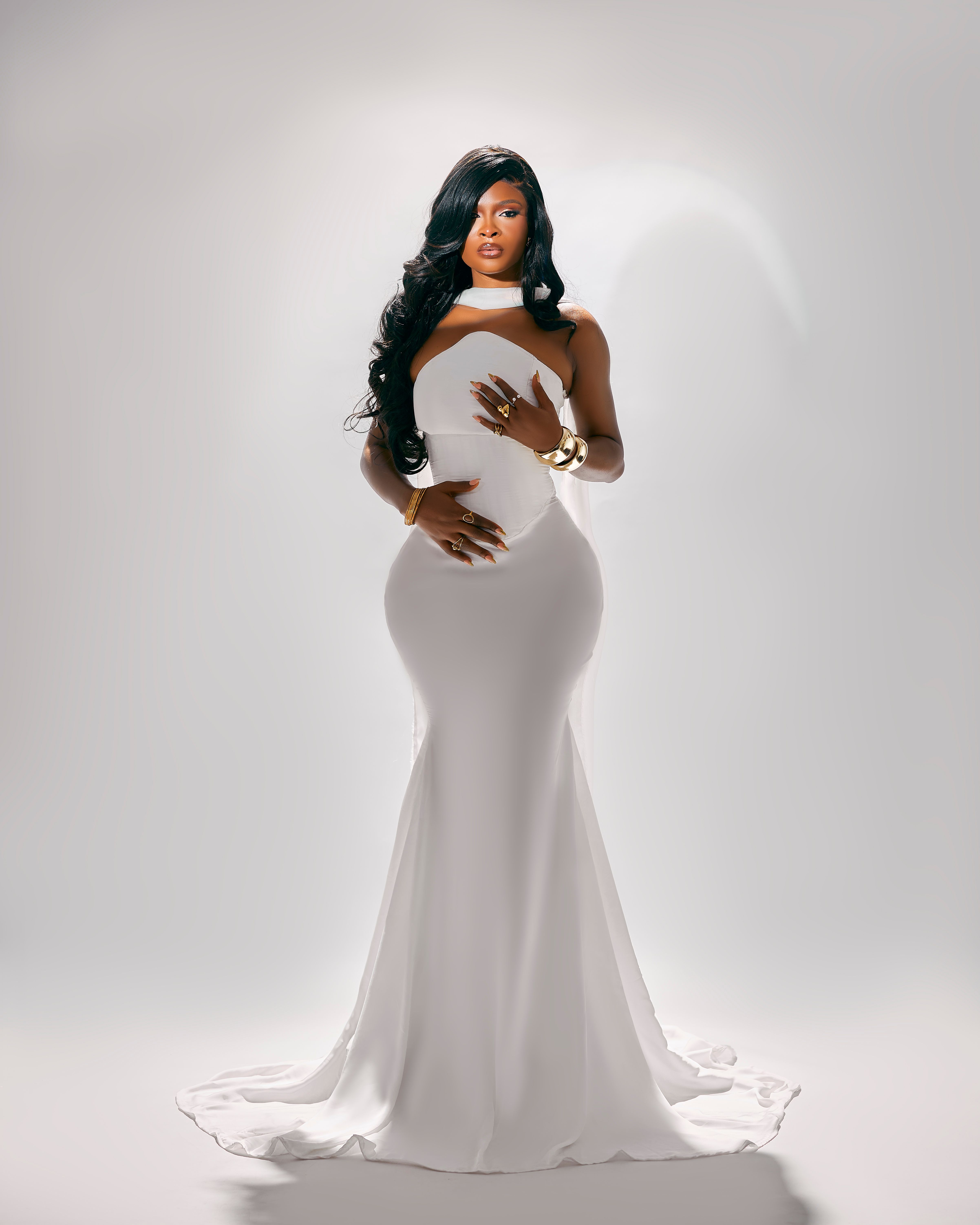 Elegant Woman in White Gown with Gold Accessories  Free Stock Photo