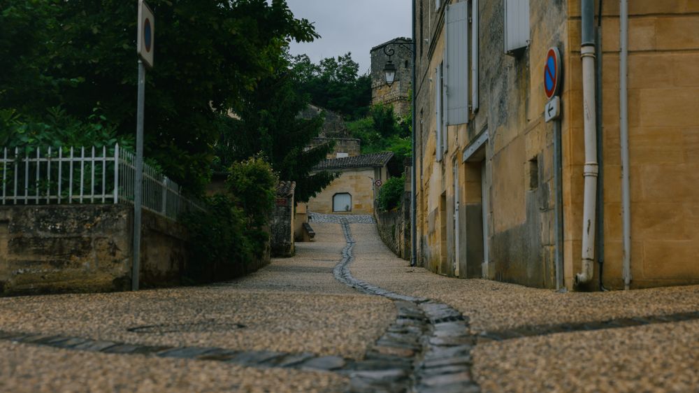 Străduță pietruită cu arhitectură tradițională în satul medieval Saint-Émilion