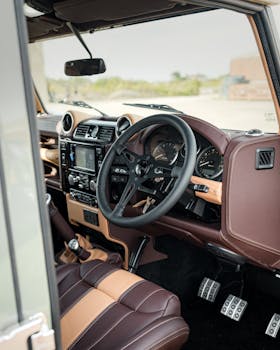High-quality shot of a luxury car interior focusing on the steering wheel and dashboard.