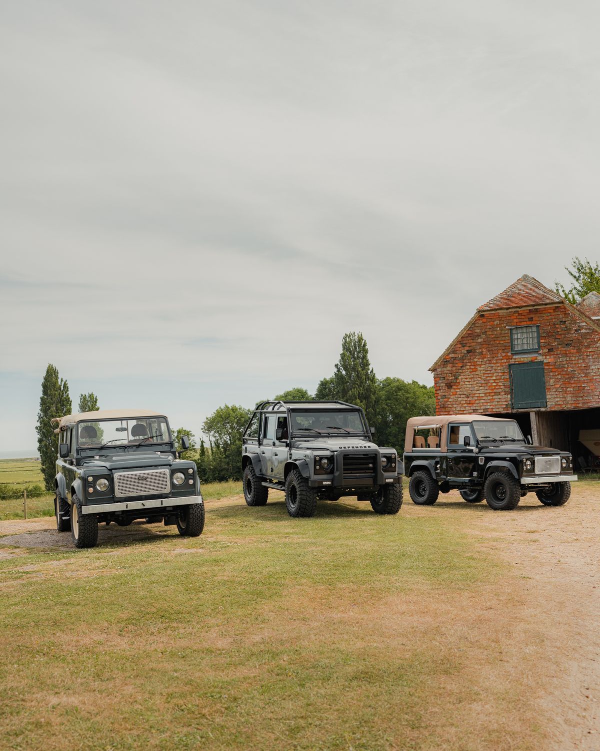 Iwm Land Rover Classic Land Rovers Parked by Rustic Barn · Free Stock Photo
