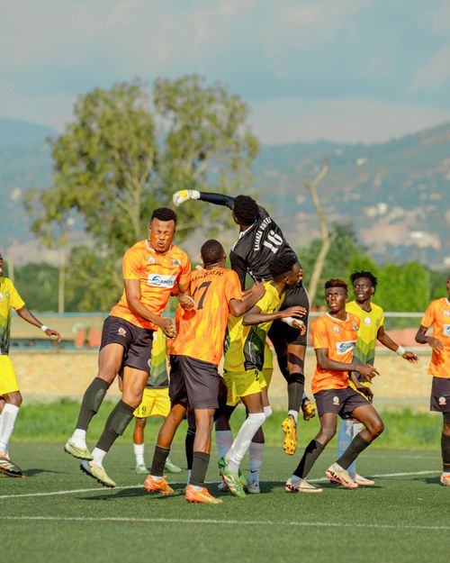 Free Dramatic moment during a soccer match with players leaping for the ball in sunny outdoor setting. Stock Photo