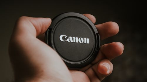 Free Close-up of a camera lens cap held in hand, perfect for photography themes. Stock Photo
