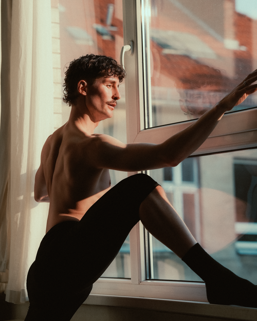 Free A man sitting by a sunlit window, contemplating the day ahead. Stock Photo