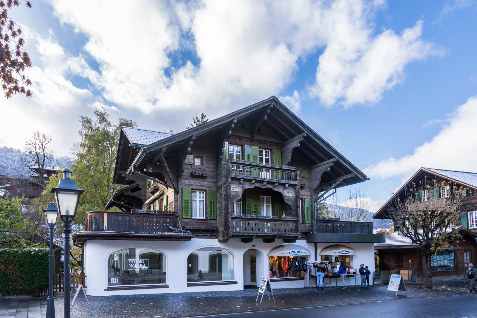Gstaad village wooden chalets church steeple alpine mountains