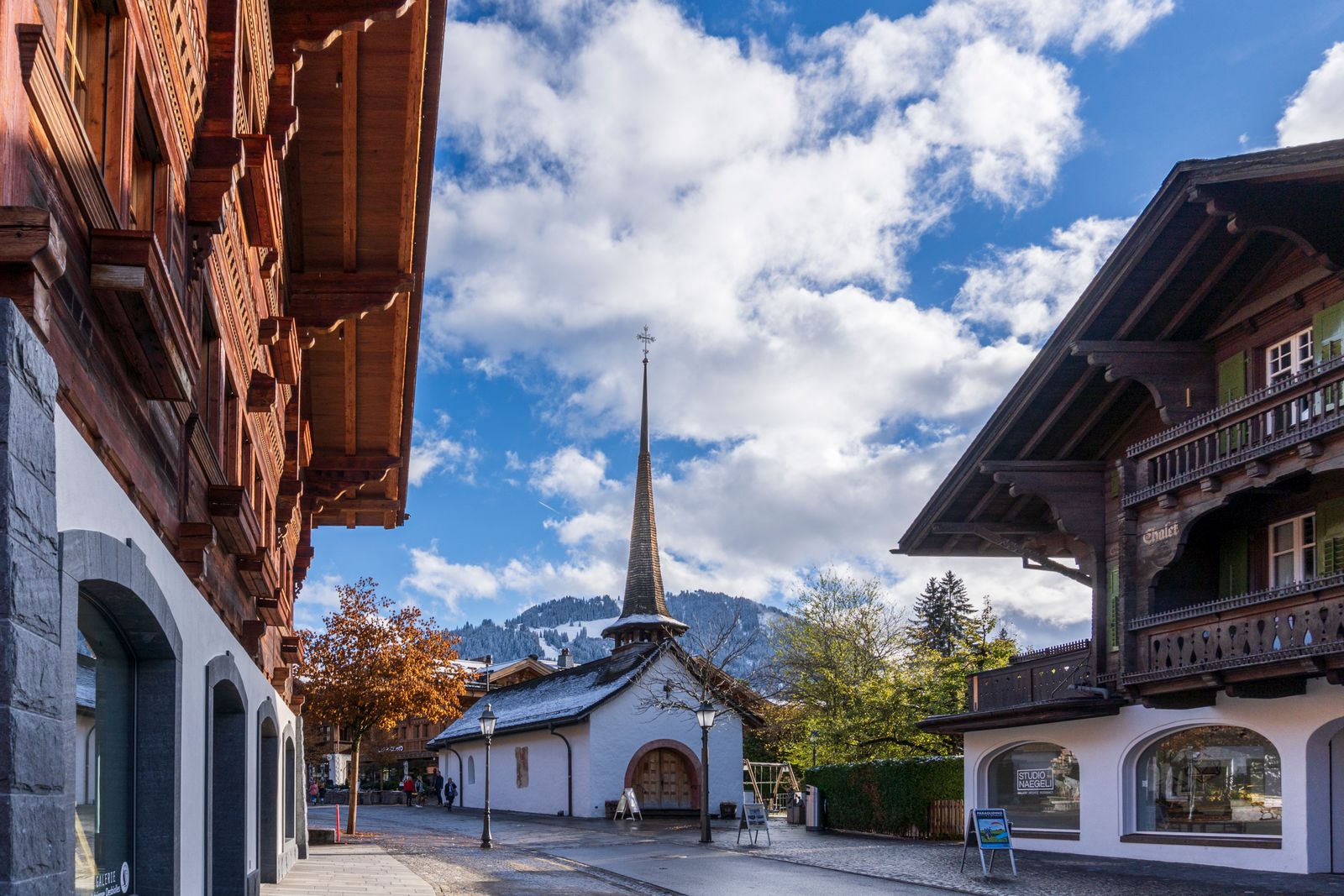 Migros Hiking Sounds and Gstaad signpost in Swiss Alps winter