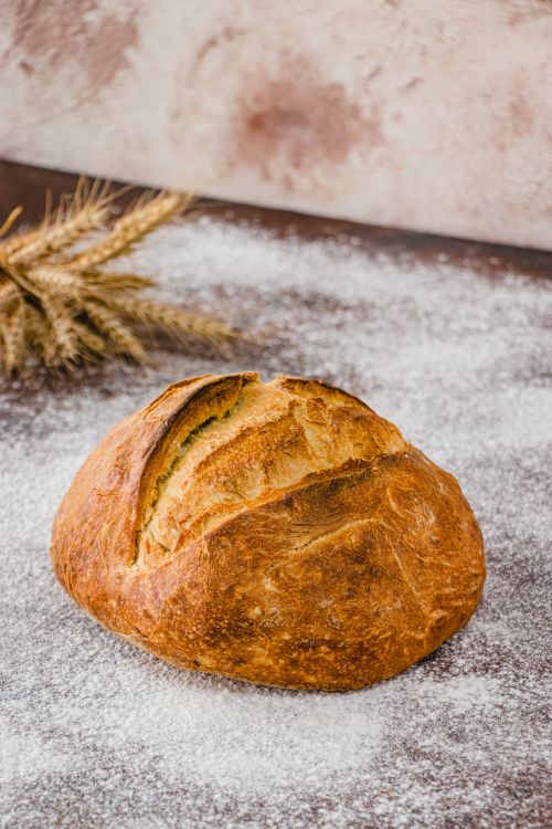 Free Golden artisan bread on a flour-dusted surface in İstanbul. Stock Photo