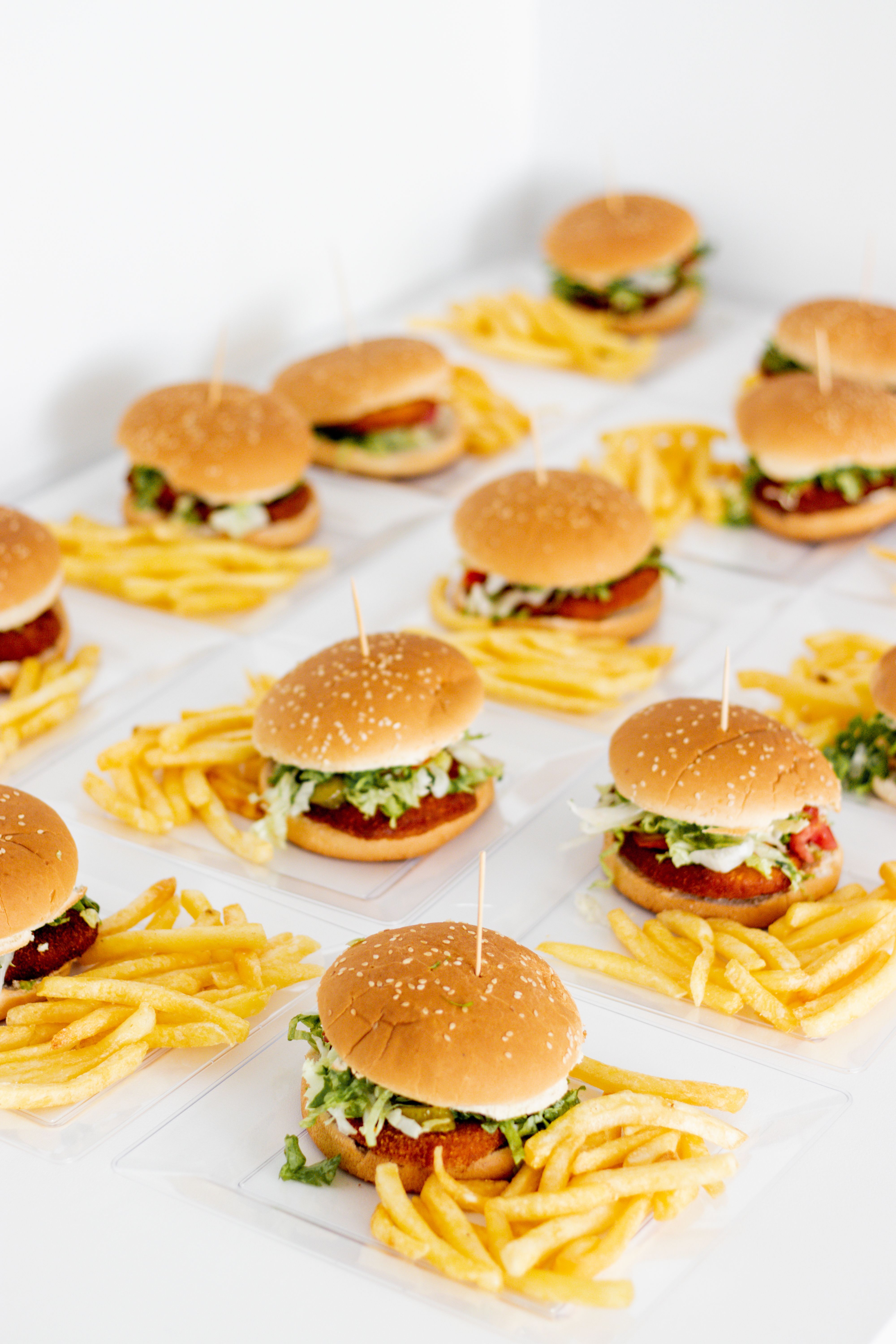 Mouthwatering burgers with crispy fries arranged in a grid, perfect for food enthusiasts.