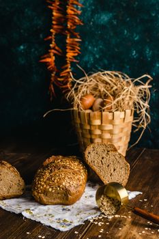 Artisan bread with oats and baskets of eggs on rustic table setting, perfect for culinary themes.