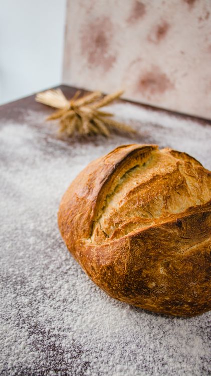 Rustic Table Bread Artisanal Bread Loaf on Rustic Flour Table · Free Stock Photo