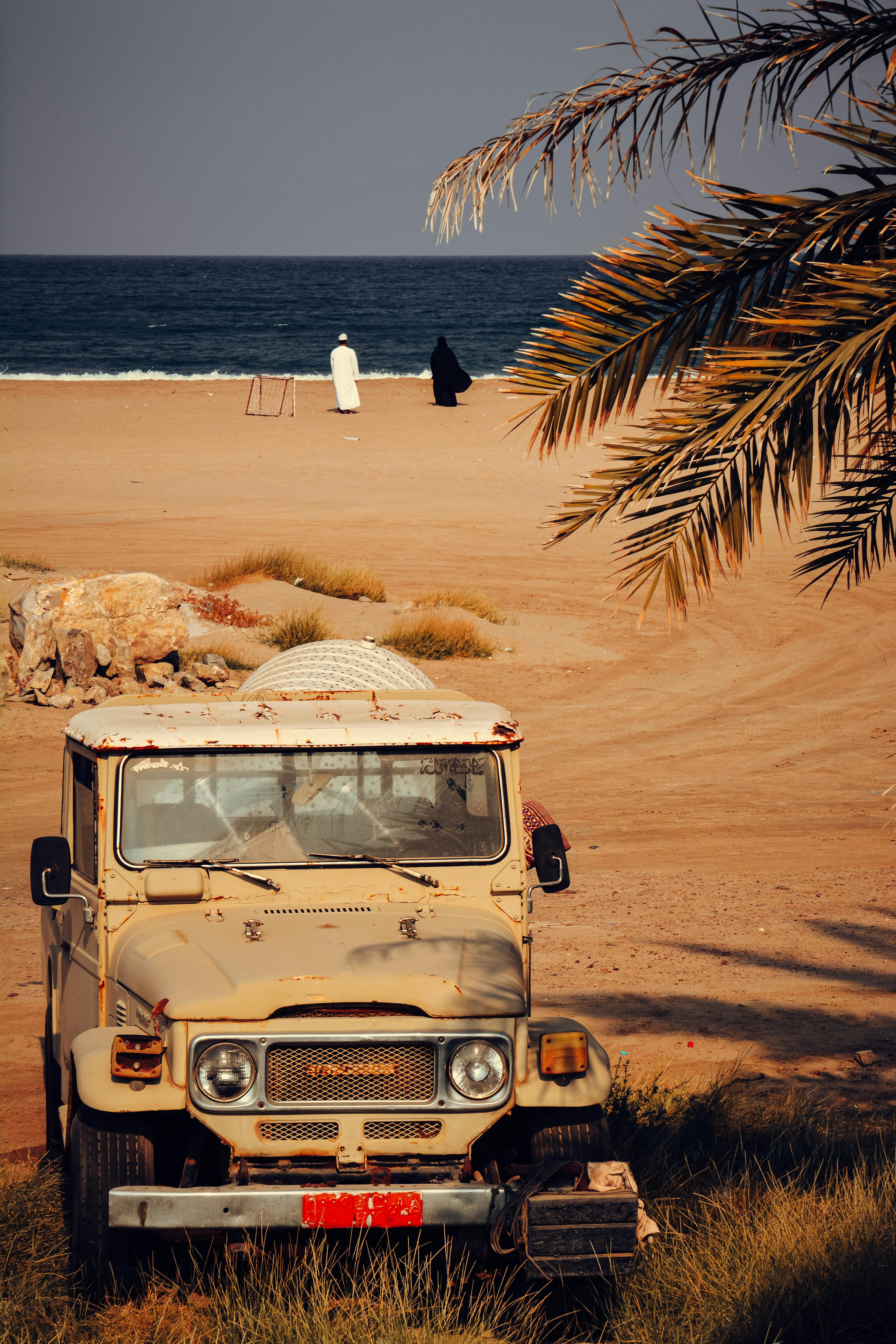 vintage jeep on oman s sandy beachfront