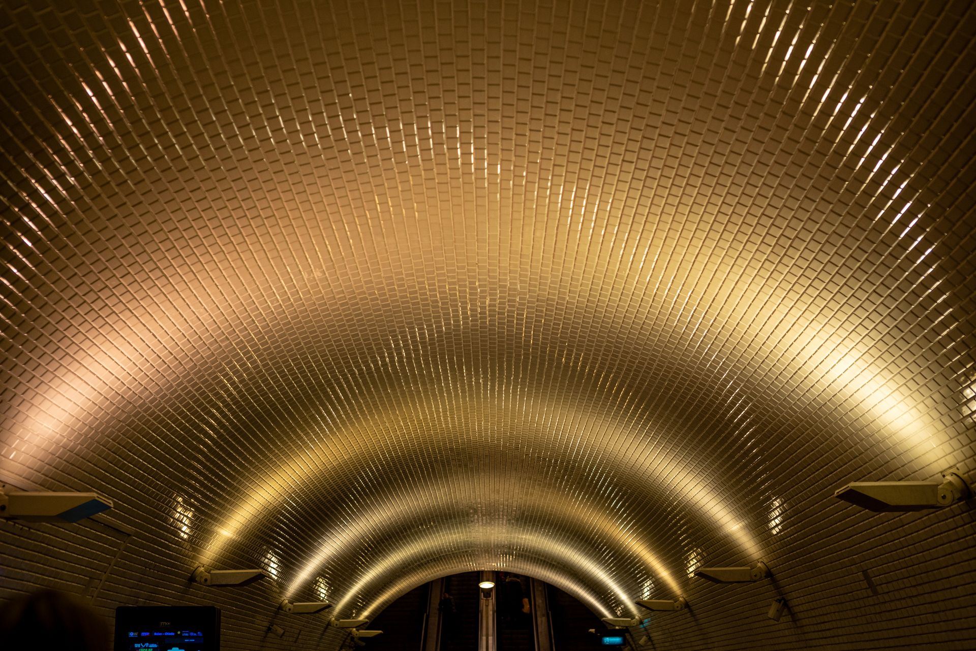 Stunning view of the illuminated arched tiled ceiling in Lisbon metro station.