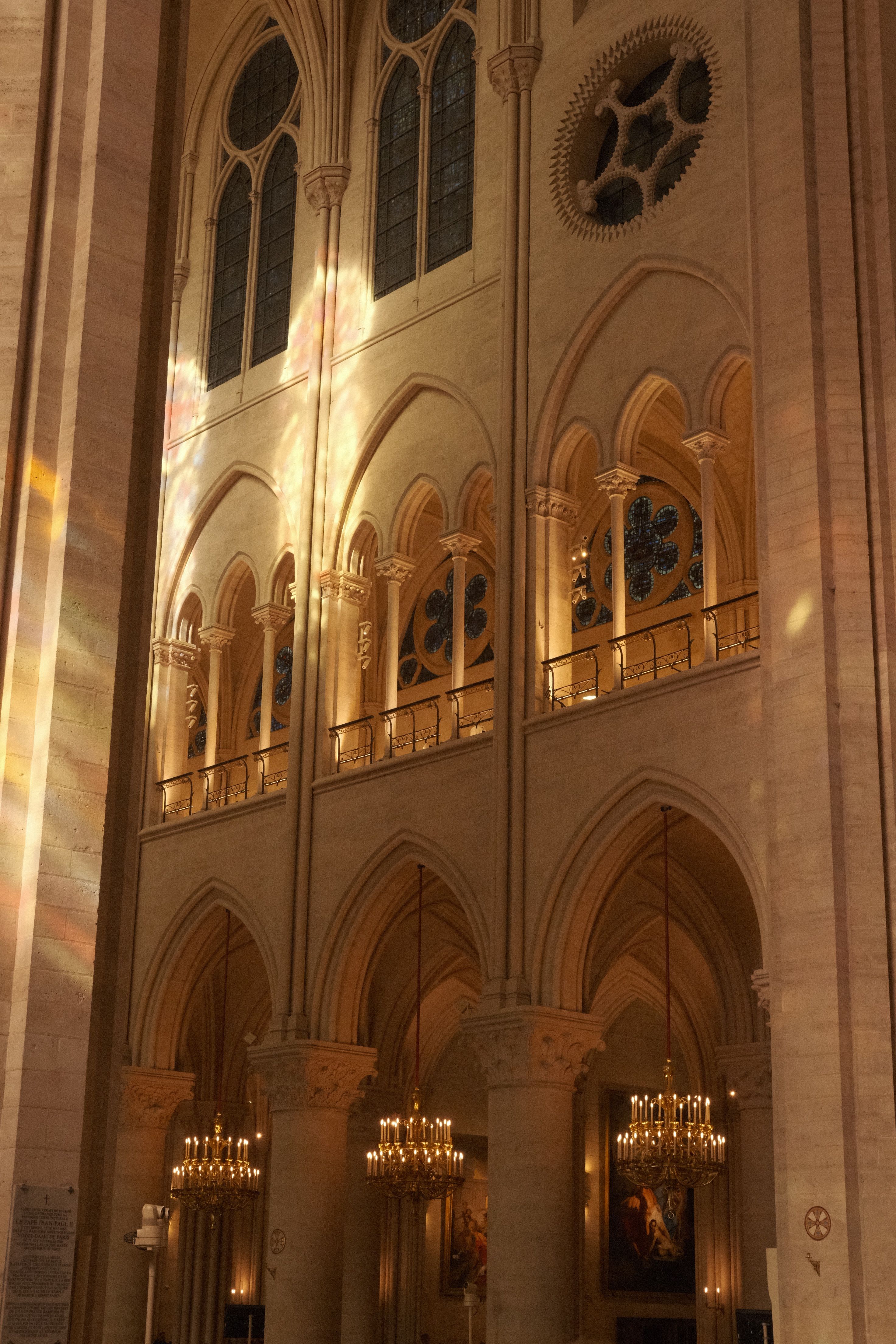 Beautiful light play inside Notre Dame Cathedral, Paris, showing gothic architecture.