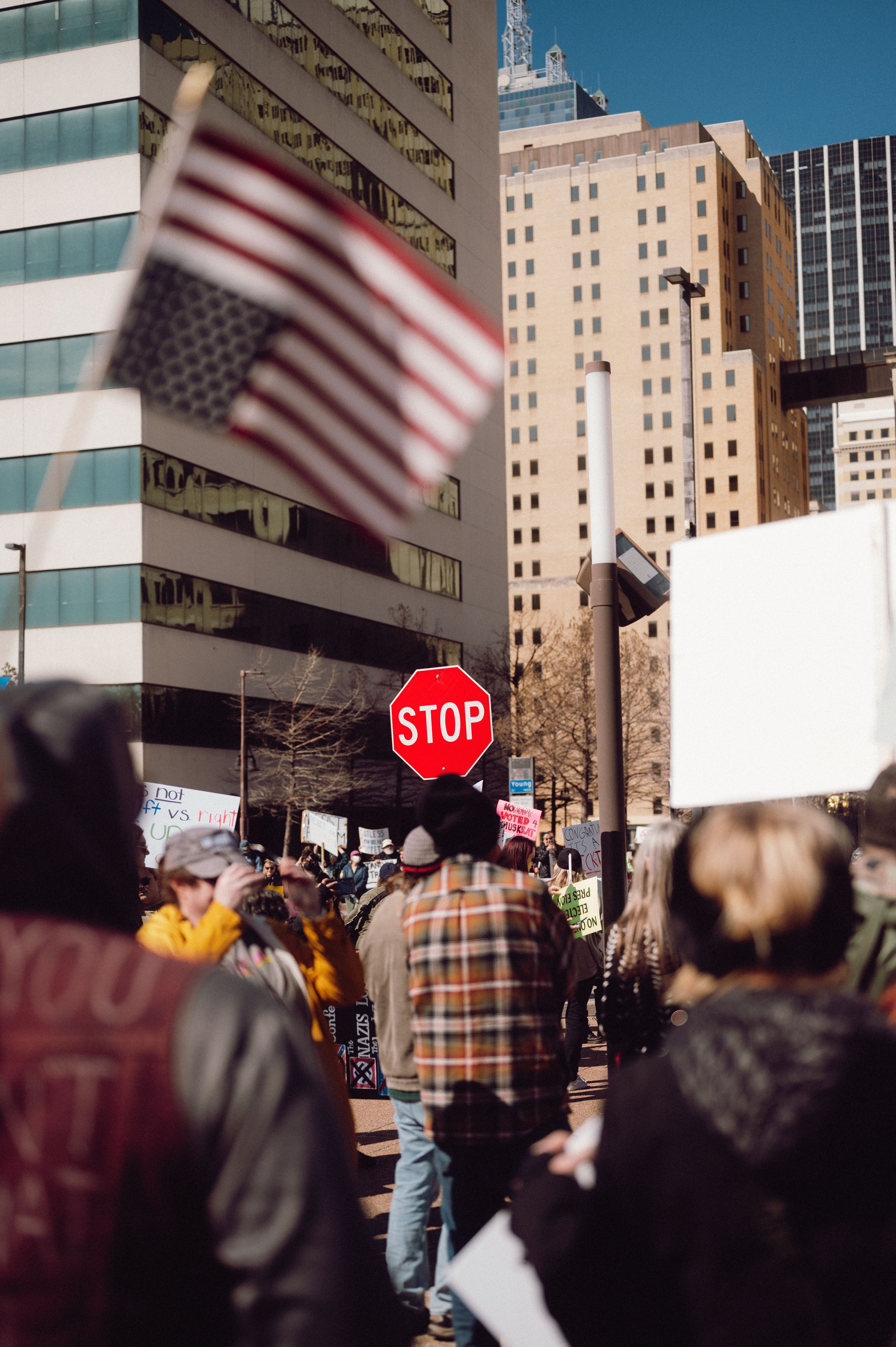 Protest in Urban City Street with US Flag and Signs · Free Stock Photo