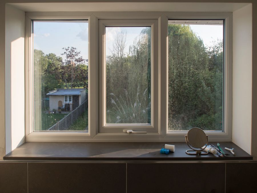 White uPVC window unit framing a garden view