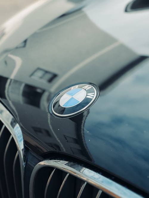 Free A detailed shot of a car emblem on a glossy vehicle hood, highlighting automotive design. Stock Photo