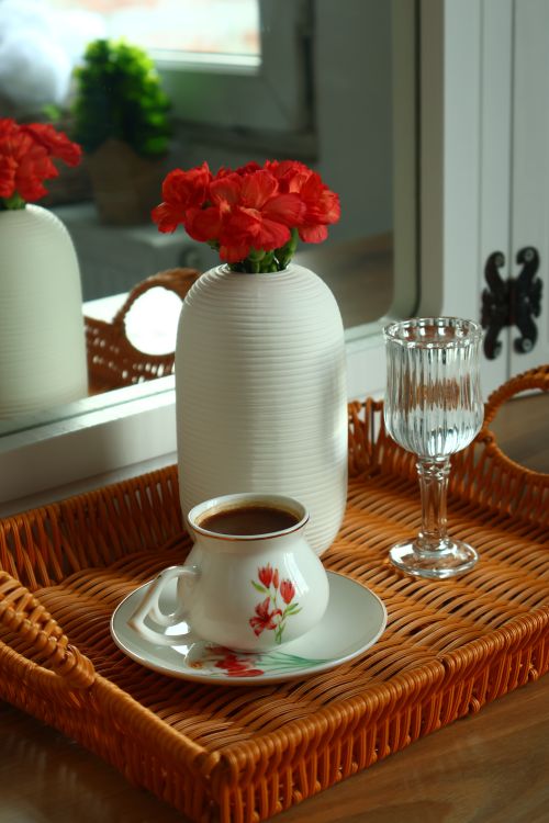 Free Stylish coffee setting with a white vase of red flowers in a wicker tray. Stock Photo