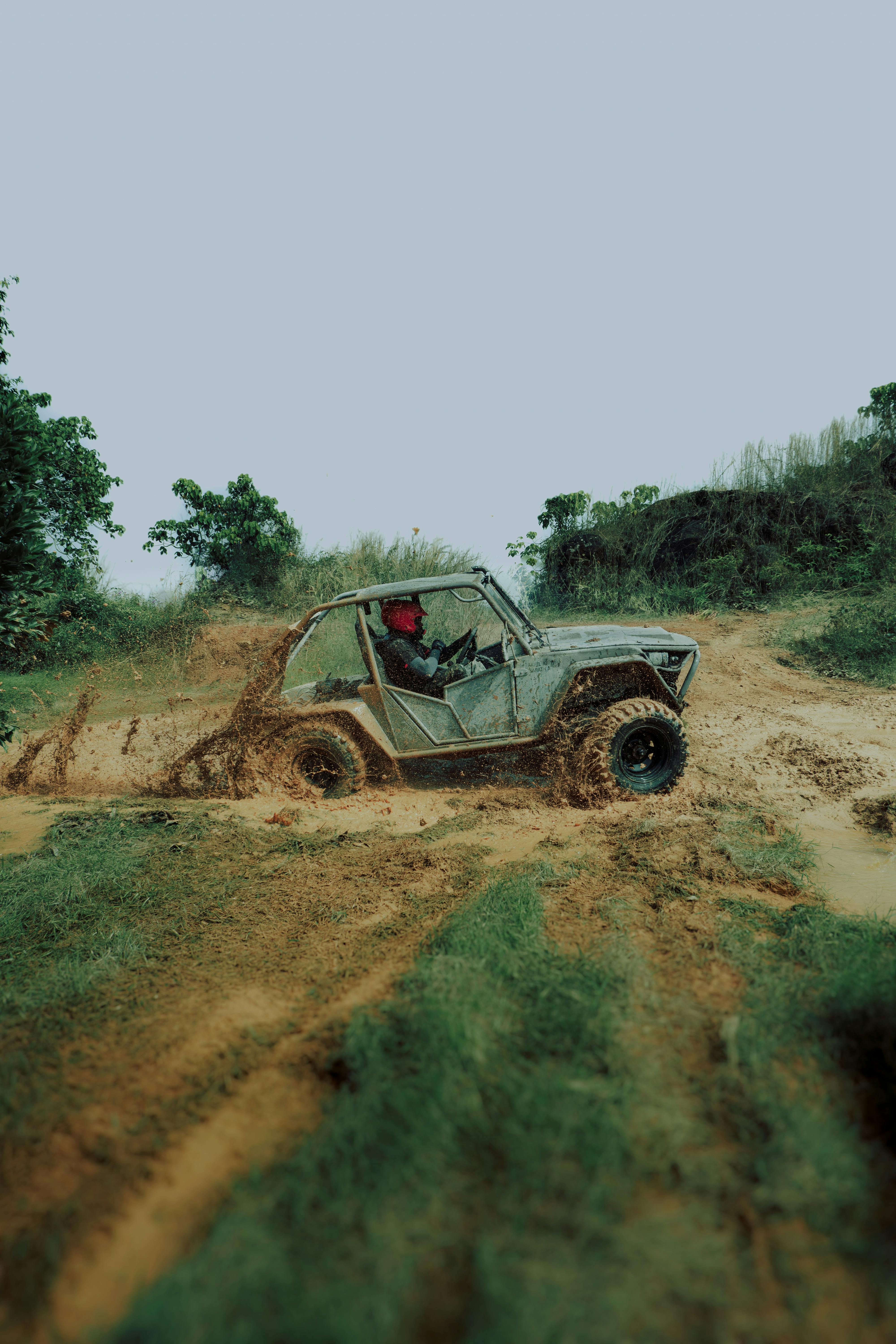 An exhilarating shot of an ATV navigating a muddy off-road course, perfect for adventure themes.
