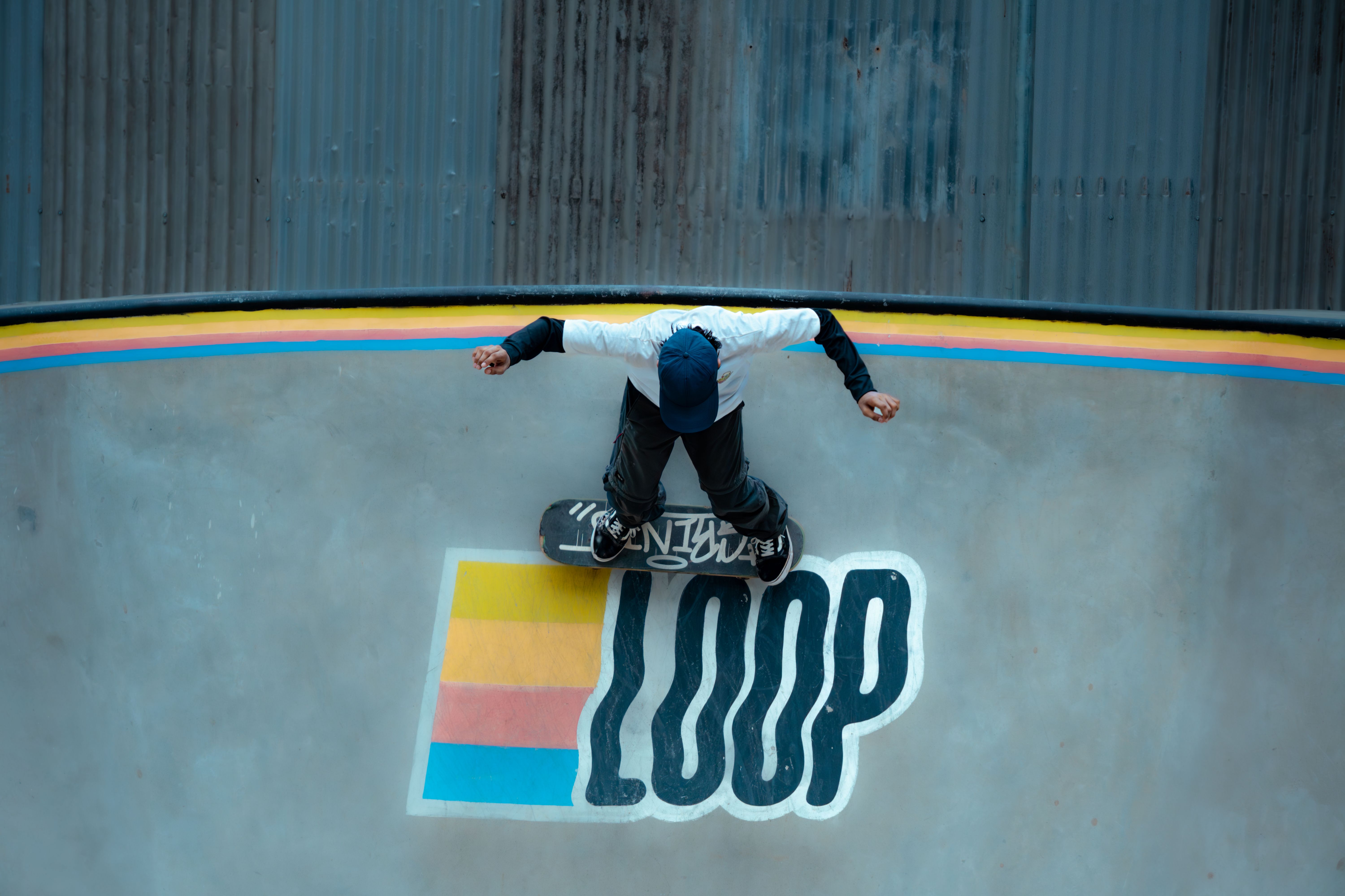Skateboarder Performing Trick on Loop Ramp · Free Stock Photo