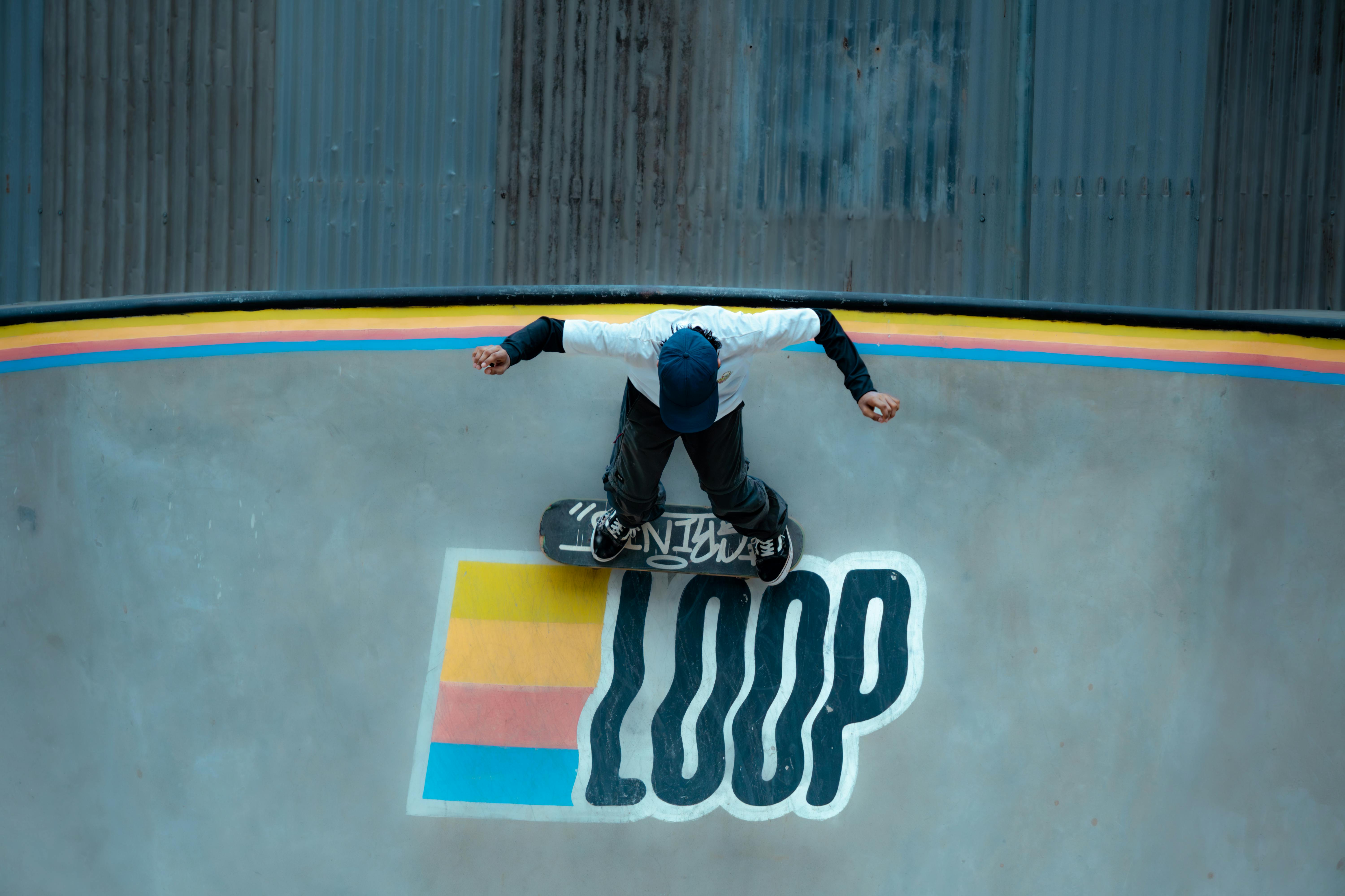 Skateboarder Performing Trick on Loop Ramp · Free Stock Photo