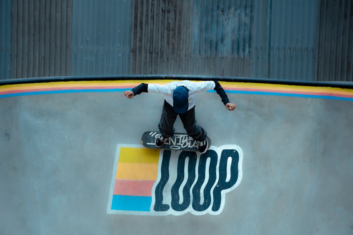 Skateboarder Performing Trick on Loop Ramp Β· Free Stock Photo