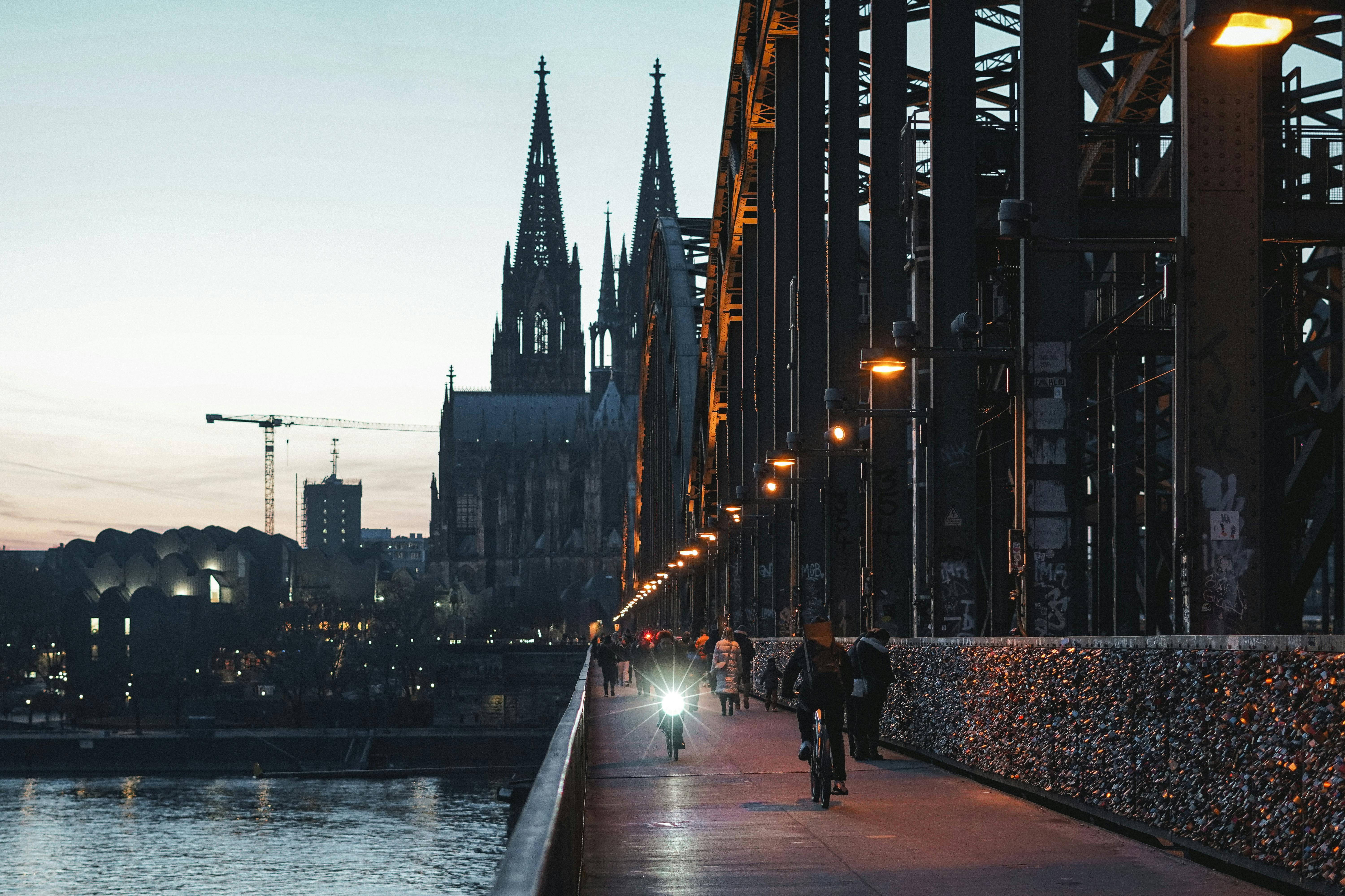 Family walking along Rhine promenade at dusk