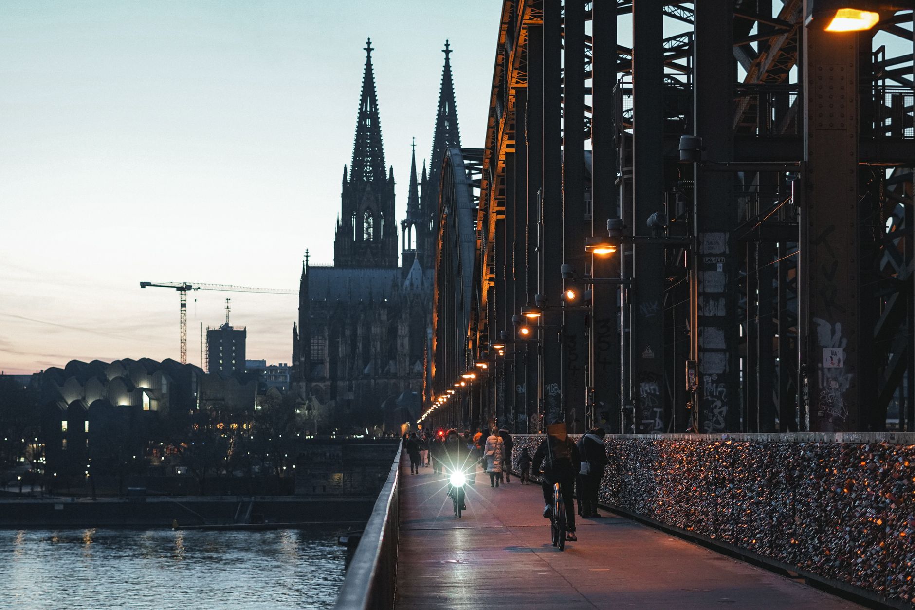 Family walking along Rhine promenade at dusk