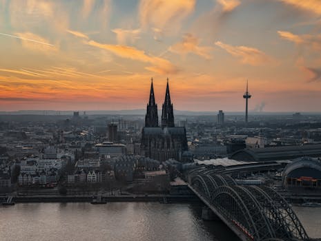 Captivating sunset over Cologne, featuring the iconic Cologne Cathedral and vibrant sky colors.