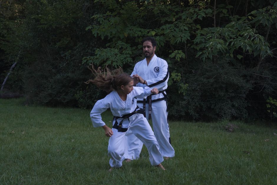 female blackbelt defending against attacker self defense system real world combat