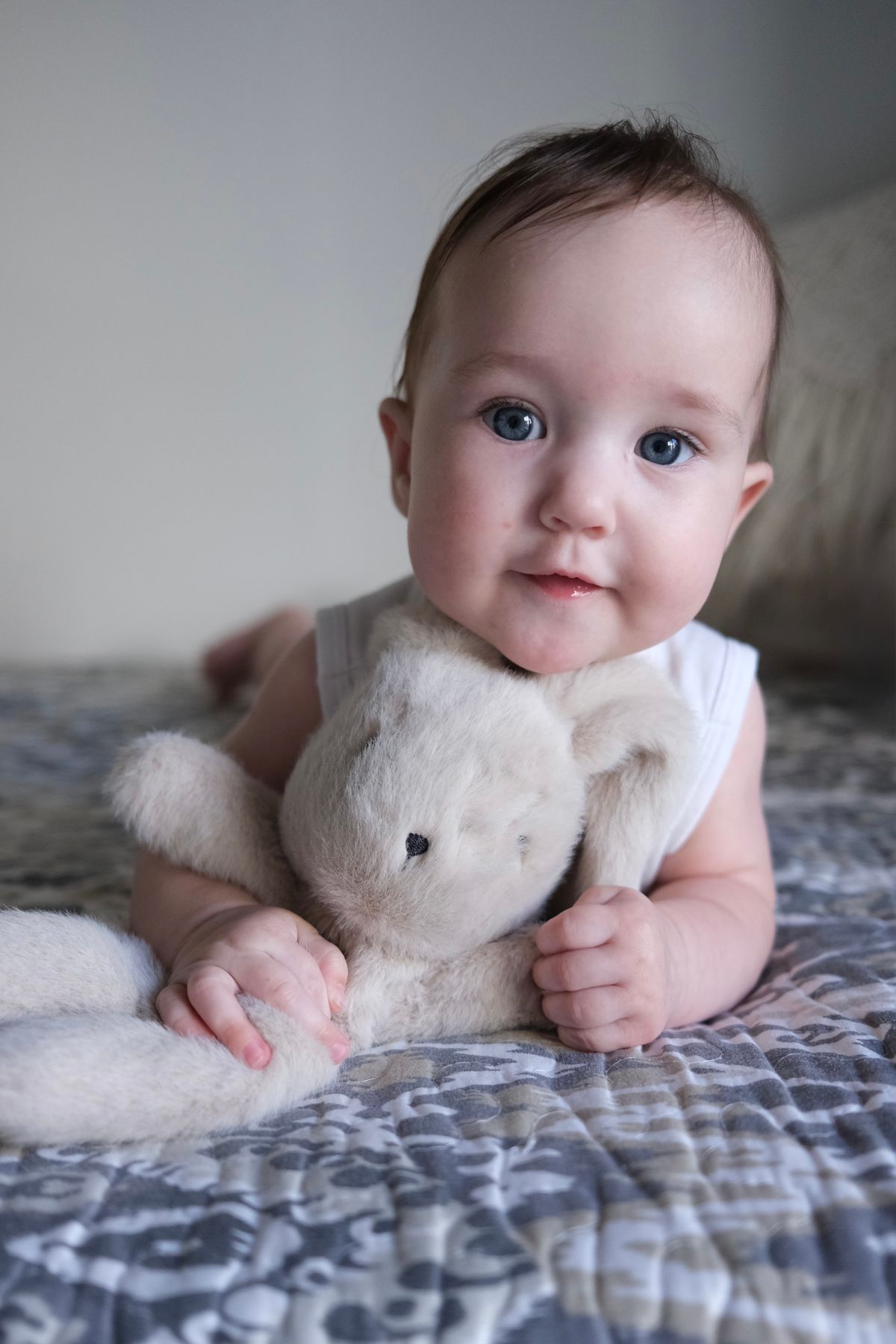 Baby cuddling a soft toy