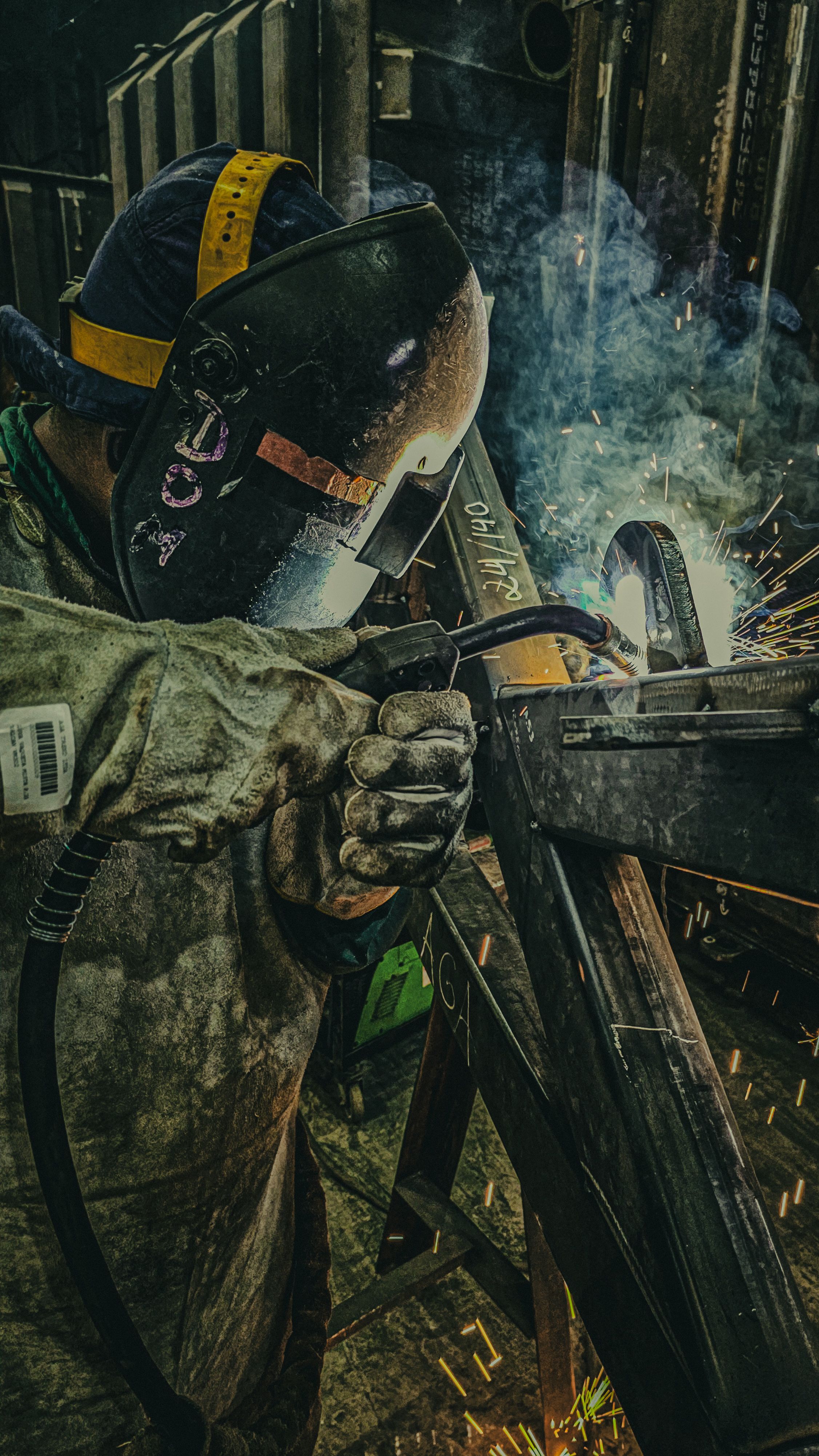 Welder fabricating structural steel with sparks