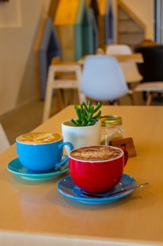 Brightly colored coffee cups on a table in a stylish café in Victoria, Australia.