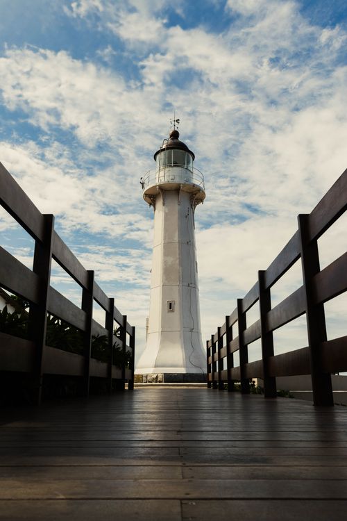 Free Stunning view of a lighthouse situated on a jetty in Vila Velha, Espírito Santo, Brazil. Stock Photo