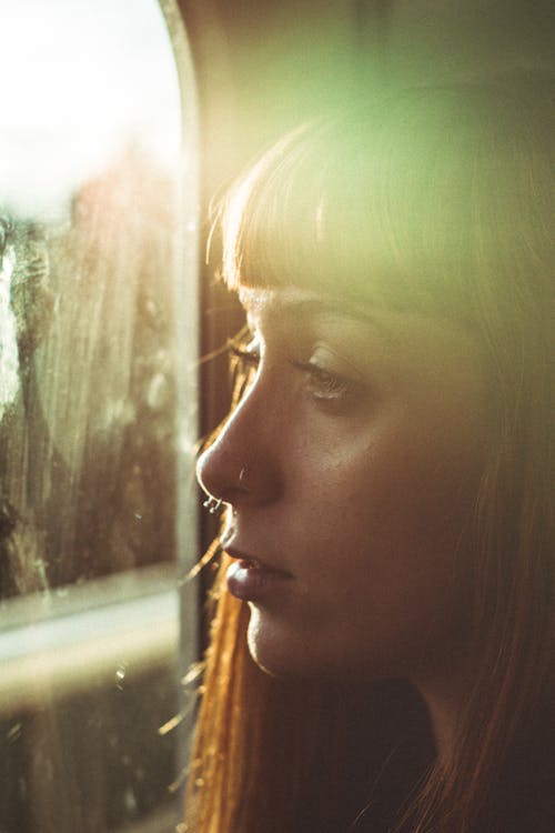 Woman Looking Through a Window