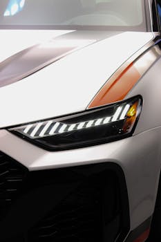 Close-up view of a sleek modern car headlight with LED lights.