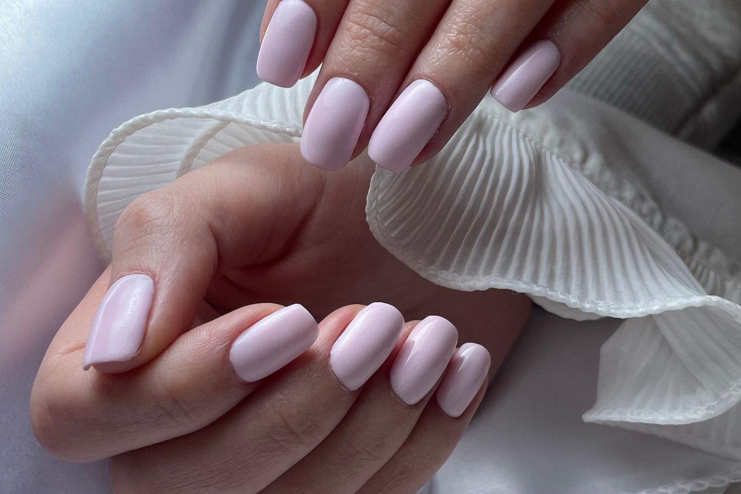 Blush pink polish on short elegant nails