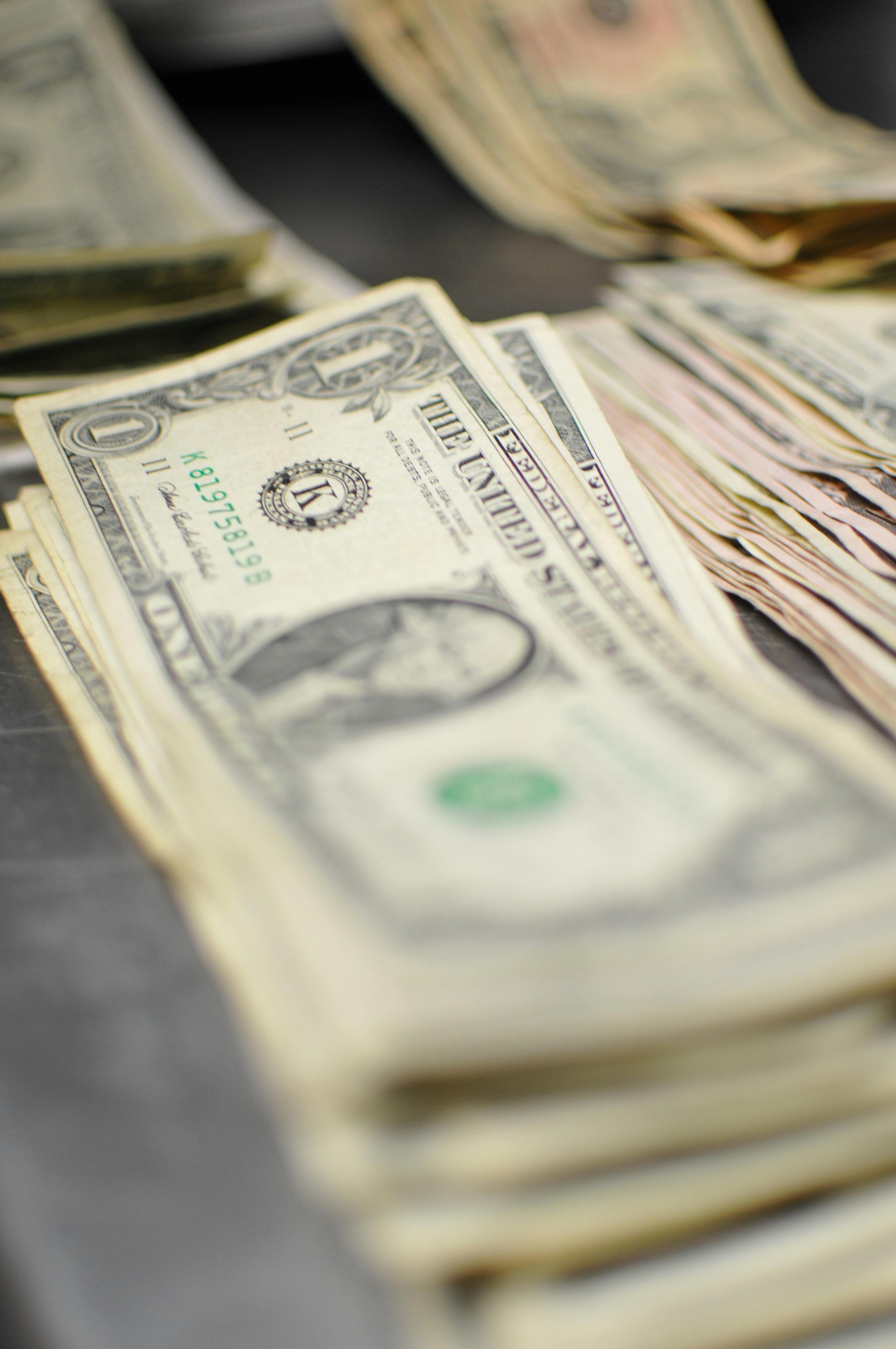 Close-up of US dollar bills in a stack suggesting finance and currency.