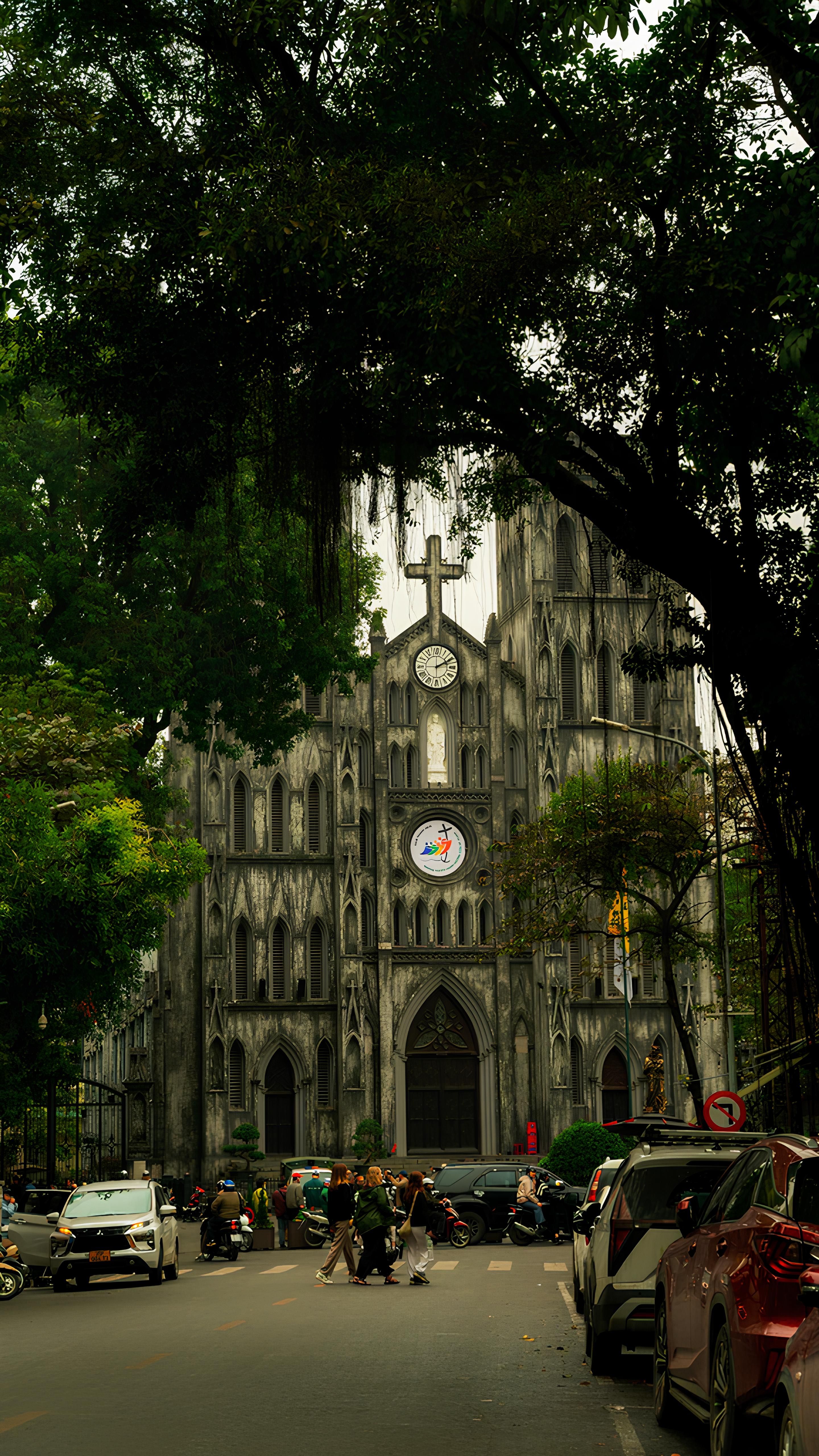 Stunning view of St. Joseph's Cathedral in Hanoi, enveloped by greenery and urban life.
