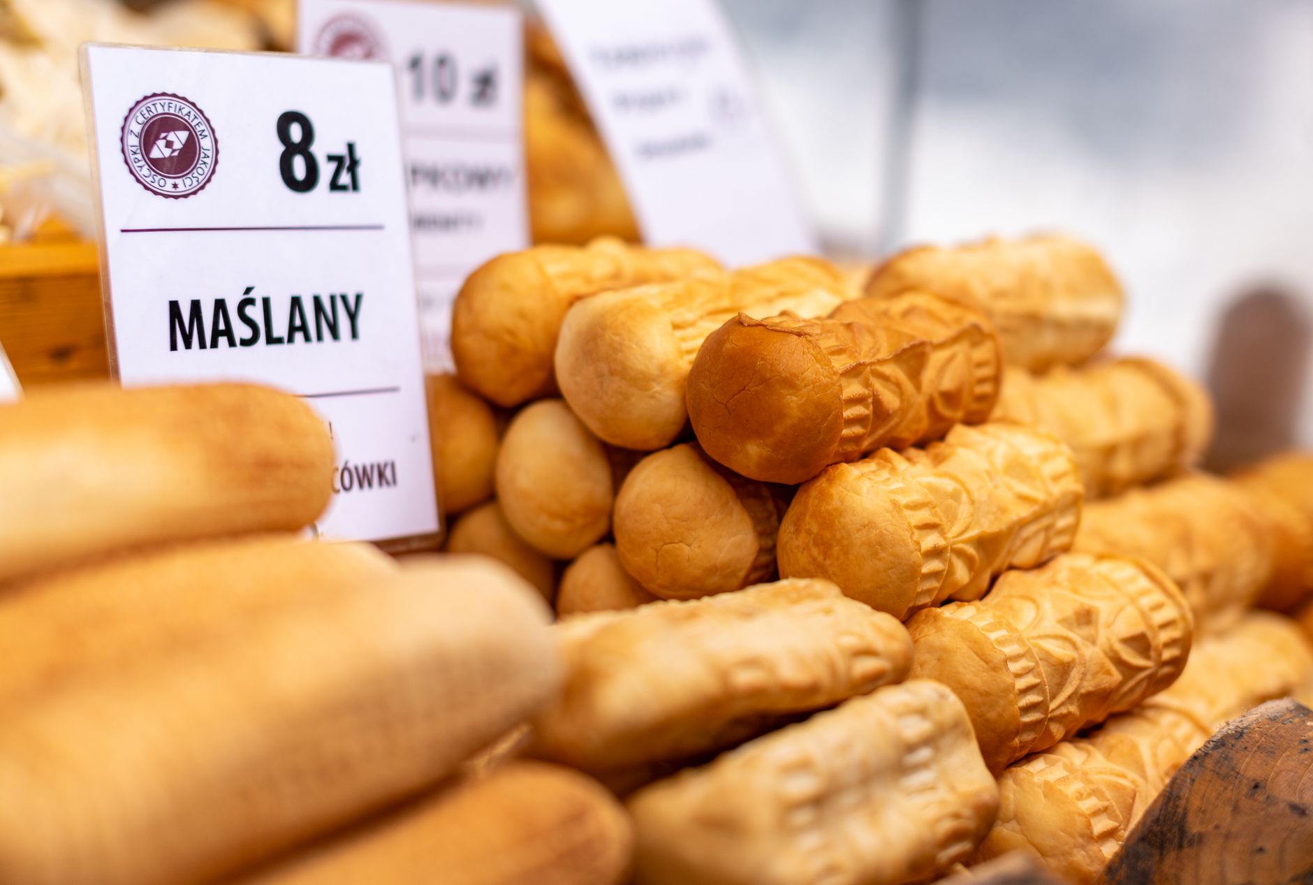 Delicious traditional smoked Oscypki cheese on display in Zakopane market, Poland.