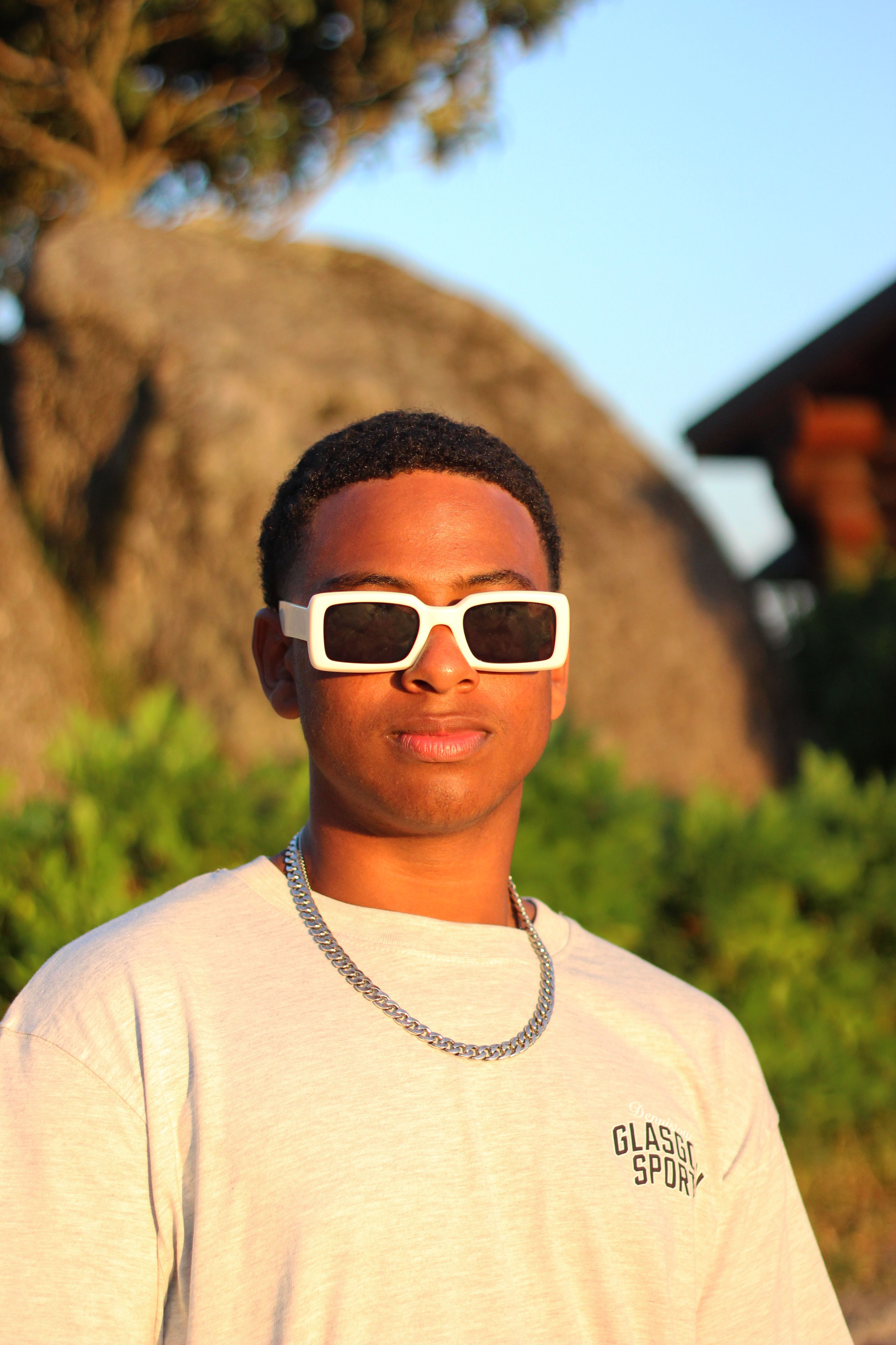 Portrait of a young man wearing sunglasses at sunset in Póvoa de Lanhoso.