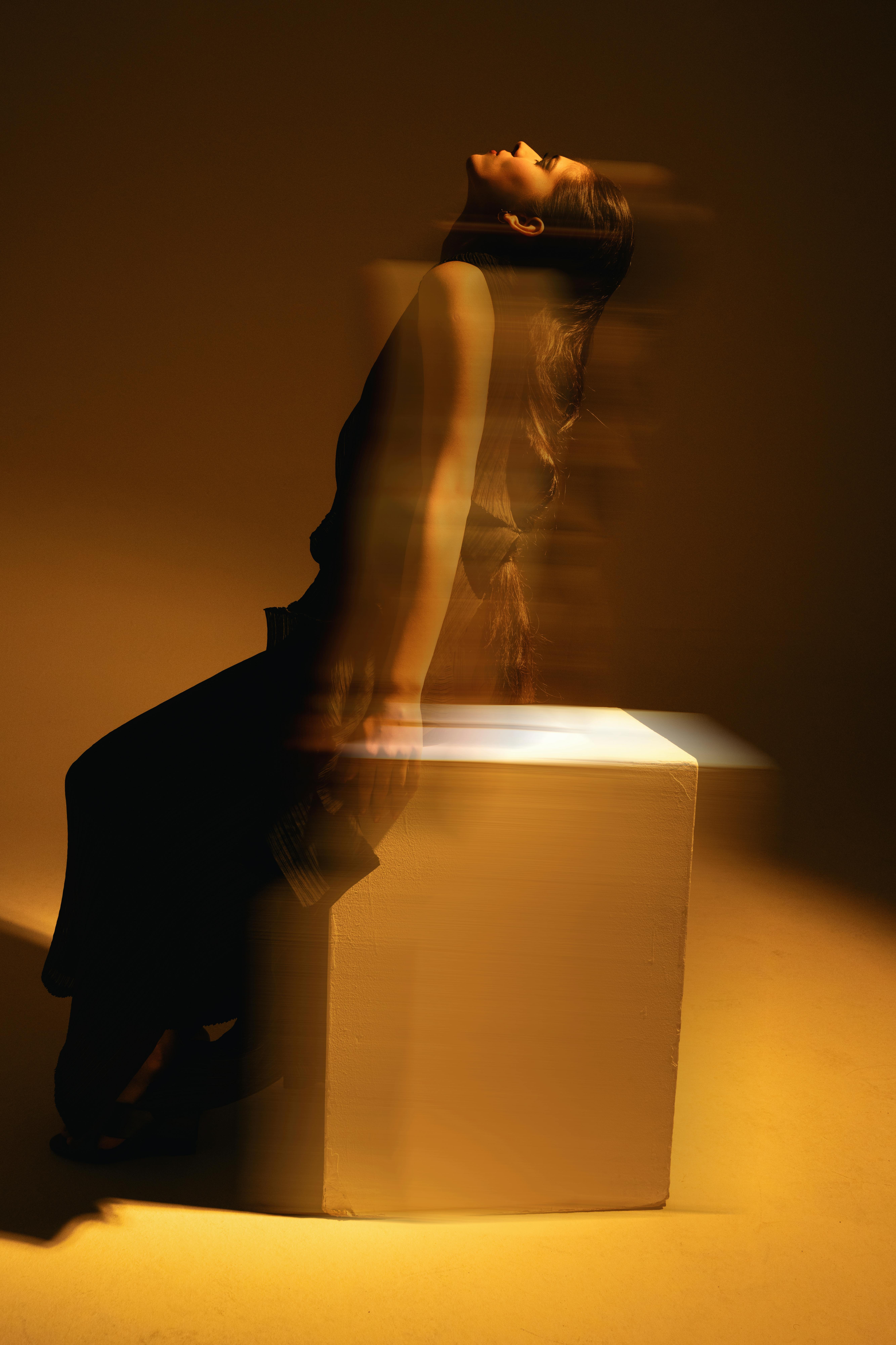 A creative studio portrait in London with dramatic lighting and motion blur.