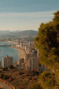 Aerial shot of Benidorm's stunning coastline with modern skyscrapers and sandy beaches.