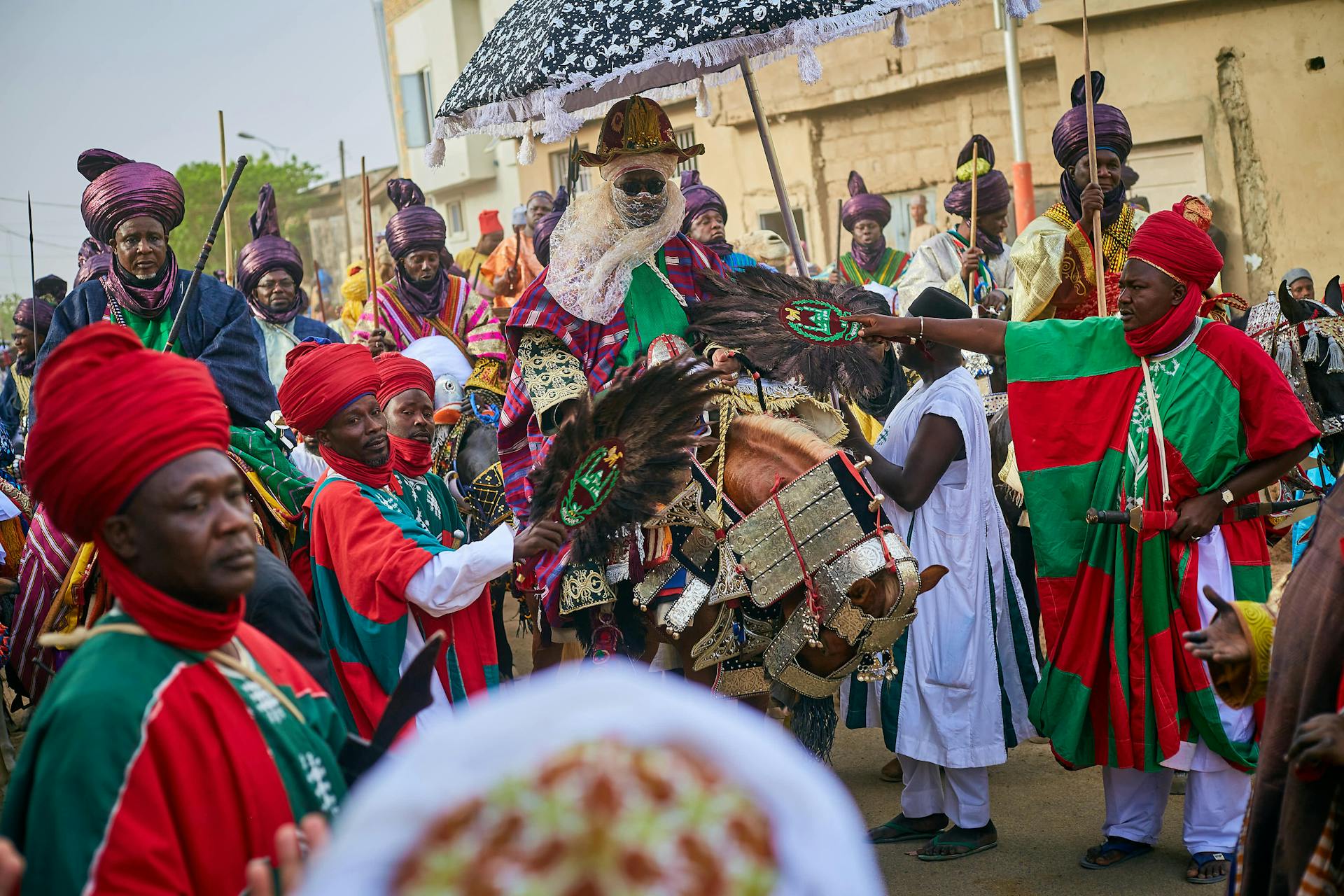 Colorful gathering of people in traditional Nigerian attire celebrating a cultural festival.