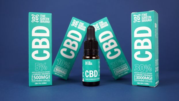 High-quality CBD oil products in branded packaging against a blue background.