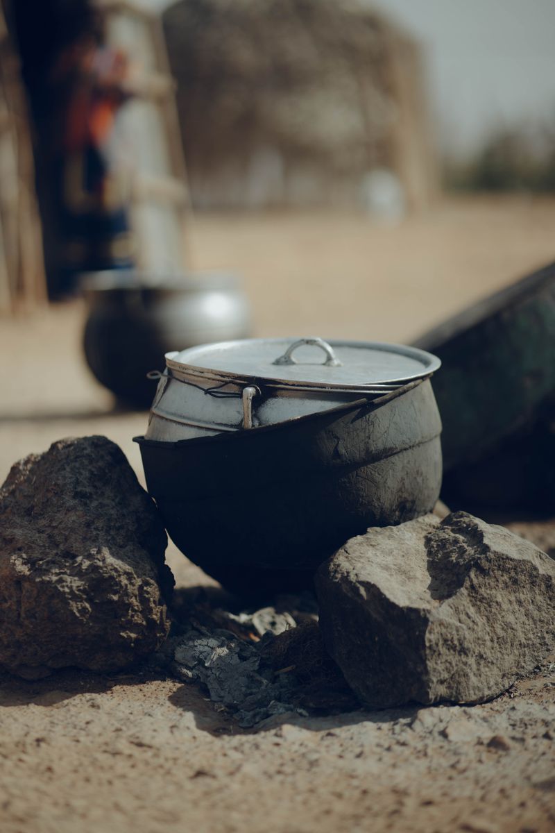 Traditional African cooking pot on rocky ground