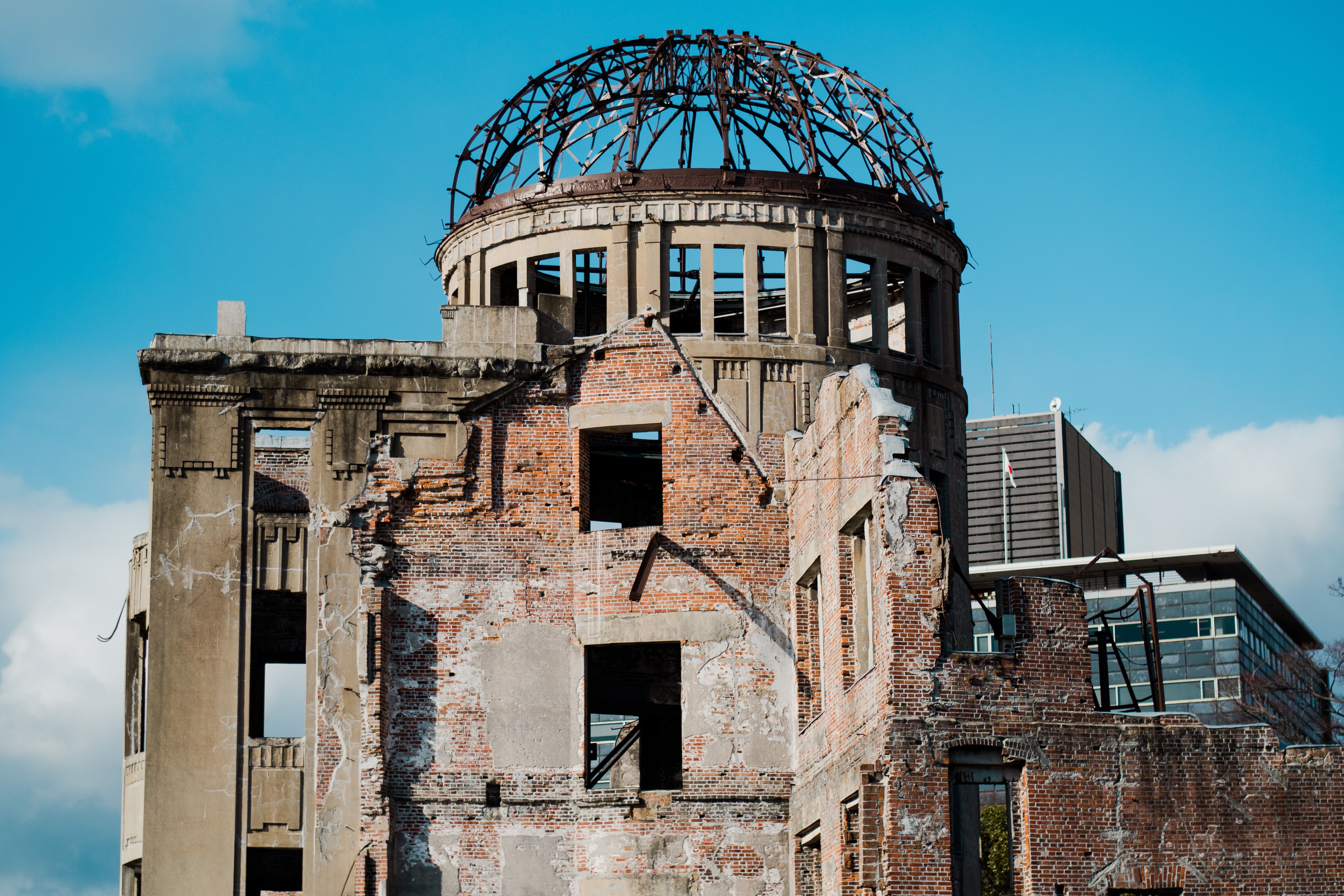 Historic Hiroshima Peace Memorial, a UNESCO site, under a clear blue sky.