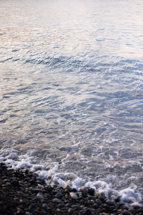 Free Tranquil scene of waves and pebbles at a Batumi beach during sunset, Georgia. Stock Photo