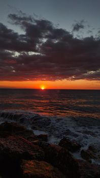 Stunning sunset view with dramatic clouds over the Mediterranean Sea in Mersin, Türkiye.